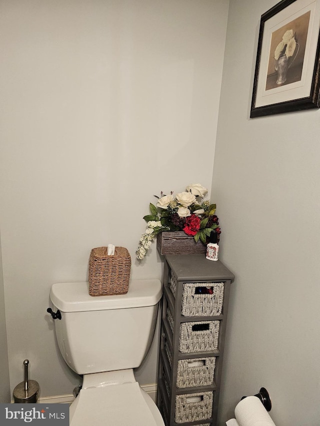 bathroom with toilet and baseboards