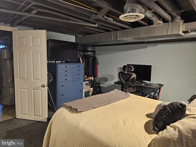 bedroom with dark carpet, water heater, and a closet