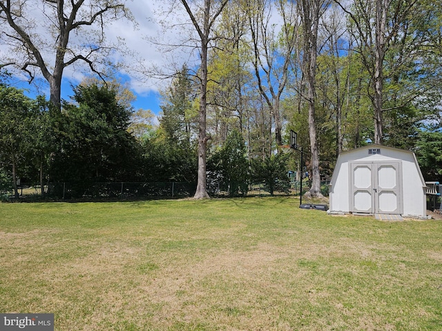 view of yard with an outdoor structure, a storage shed, and fence