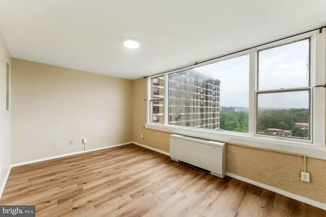 4600 Duke St Unit 1118, Alexandria, VA 22304 - spare room with radiator heating unit, baseboards, and light wood-style flooring