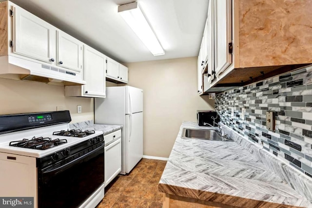 4600 Duke St Unit 1118, Alexandria, VA 22304 - kitchen featuring gas range, under cabinet range hood, a sink, freestanding refrigerator, and decorative backsplash