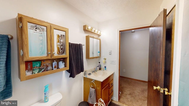 521 E Rdg Loop Rd, Romney, WV 26757 - bathroom with toilet, baseboards, vanity, and a textured ceiling