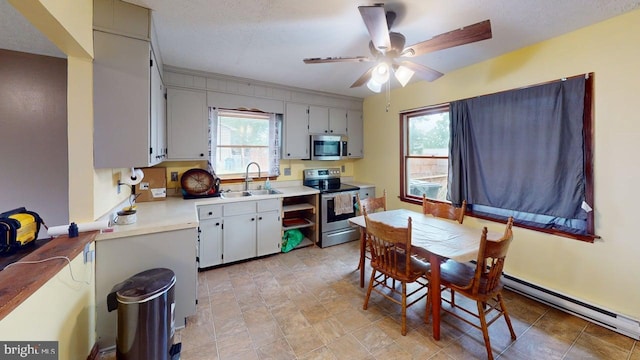 521 E Rdg Loop Rd, Romney, WV 26757 - kitchen featuring light countertops, appliances with stainless steel finishes, ceiling fan, and a sink