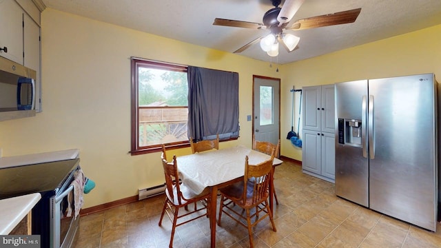 521 E Rdg Loop Rd, Romney, WV 26757 - dining space with ceiling fan, baseboards, and a baseboard heating unit