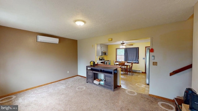 521 E Rdg Loop Rd, Romney, WV 26757 - interior space with a ceiling fan, stainless steel appliances, a textured ceiling, light colored carpet, and an AC wall unit