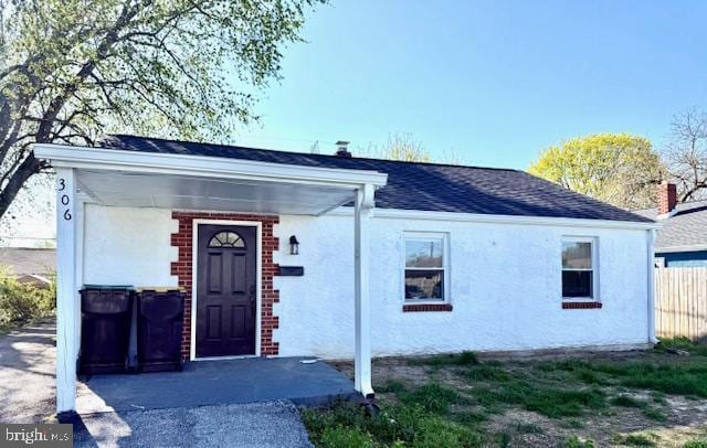 306 Elwood, New Castle, DE 19720 - exterior space with stucco siding, fence, and a shingled roof