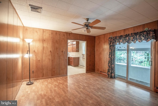 72 Bennett Dr, Doylestown, PA 18901 - unfurnished living room featuring wooden walls, wood finished floors, visible vents, and ceiling fan
