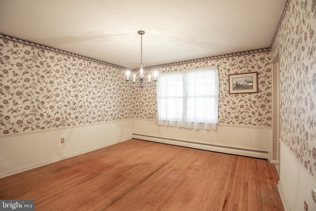 72 Bennett Dr, Doylestown, PA 18901 - unfurnished dining area featuring an inviting chandelier, wallpapered walls, baseboard heating, and wainscoting