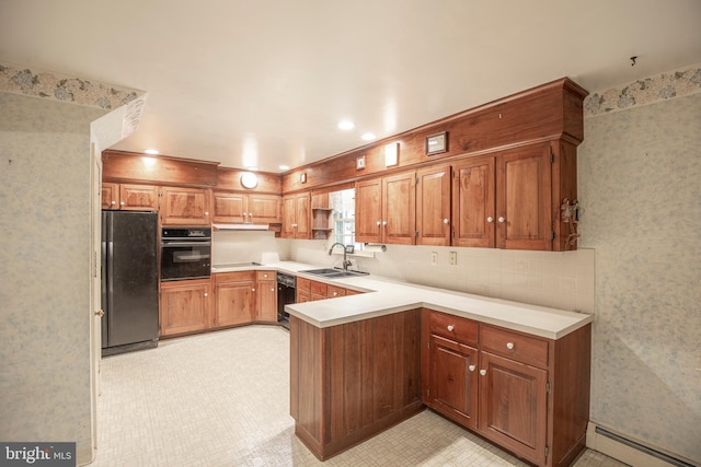72 Bennett Dr, Doylestown, PA 18901 - kitchen with a sink, light countertops, a baseboard heating unit, black appliances, and a peninsula