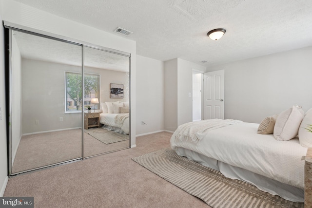 2963 Crystal Palace Ln, Pasadena, MD 21122 - carpeted bedroom featuring a closet, a textured ceiling, baseboards, and visible vents