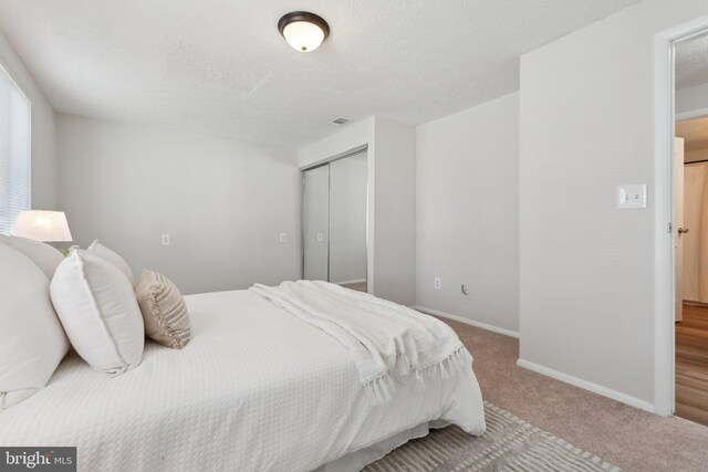 2963 Crystal Palace Ln, Pasadena, MD 21122 - bedroom with a textured ceiling, visible vents, carpet floors, baseboards, and a closet
