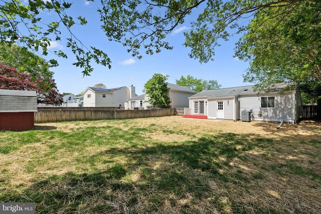 2963 Crystal Palace Ln, Pasadena, MD 21122 - view of yard featuring a storage unit, a fenced backyard, cooling unit, a patio area, and an outdoor structure