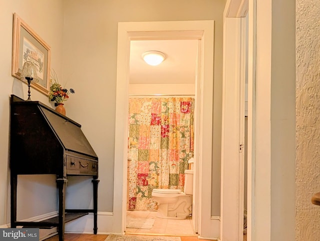 hallway featuring baseboards