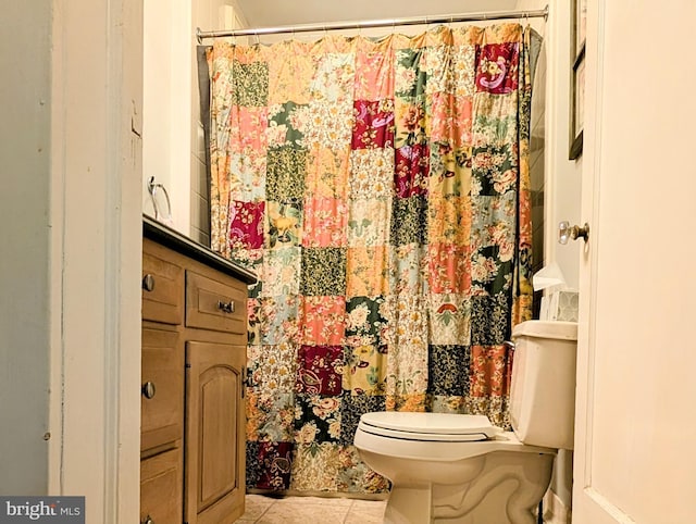 full bath featuring toilet, tile patterned floors, and a shower with curtain