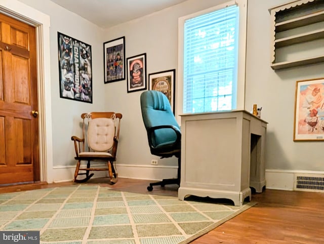 office with visible vents, baseboards, and wood finished floors
