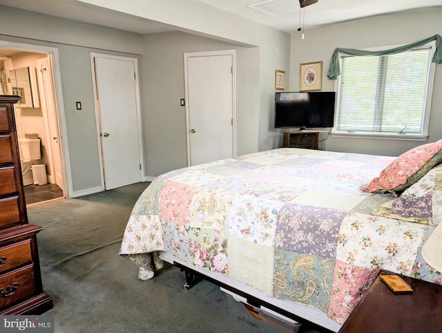 bedroom featuring ensuite bathroom and carpet flooring