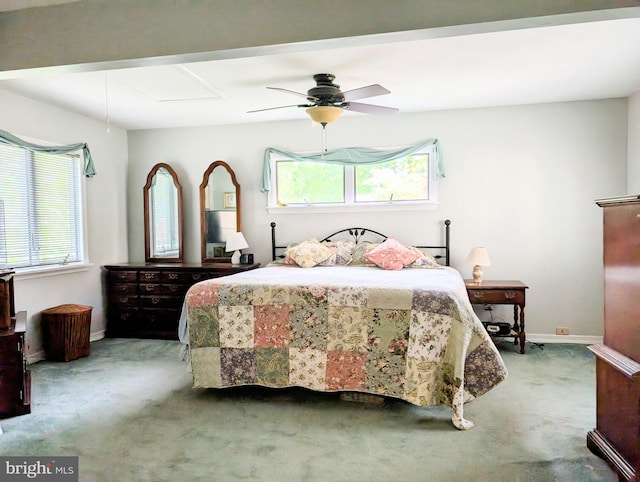 carpeted bedroom with baseboards, multiple windows, and a ceiling fan