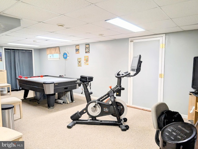 exercise area with a paneled ceiling and carpet