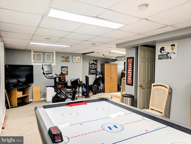 recreation room with carpet and a paneled ceiling