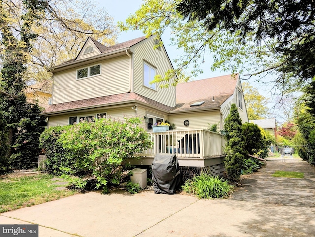 back of house with a patio and a deck