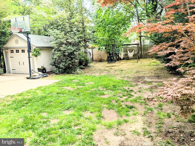 view of yard with driveway and a garage