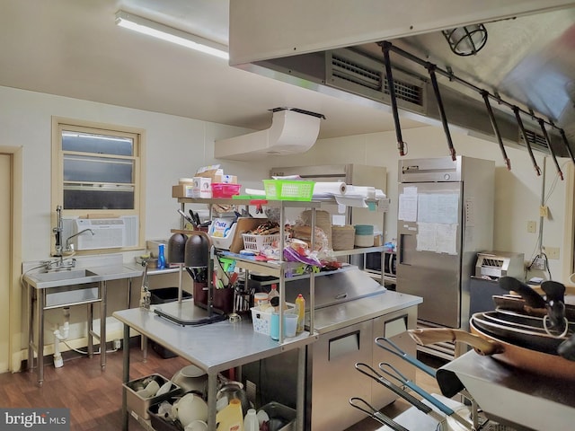 interior space featuring wood finished floors, cooling unit, and stainless steel countertops