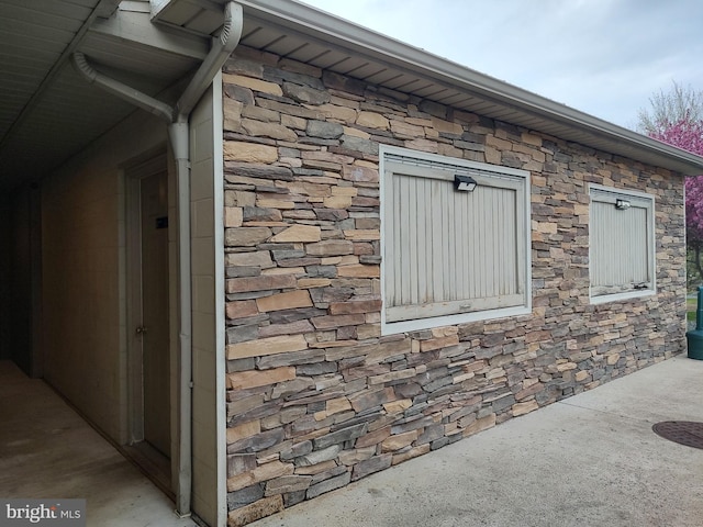 view of side of home with stone siding