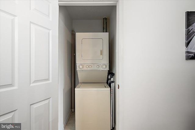 washroom with laundry area and stacked washing maching and dryer