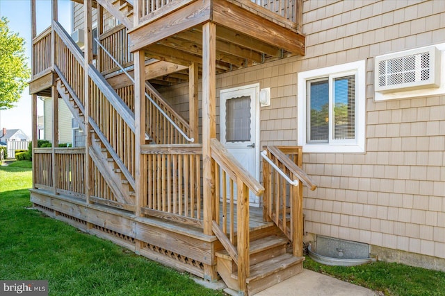 doorway to property with a wall mounted AC and a deck