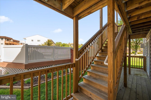 wooden deck with stairs and a yard