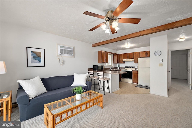 living room featuring ceiling fan, a wall unit AC, a textured ceiling, light colored carpet, and beam ceiling