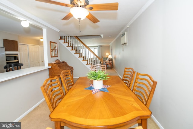 dining space featuring ceiling fan, baseboards, carpet flooring, and stairs
