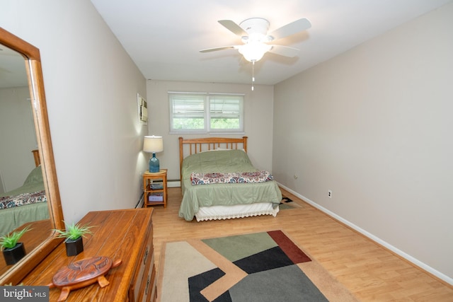 bedroom featuring wood finished floors, ceiling fan, and baseboards