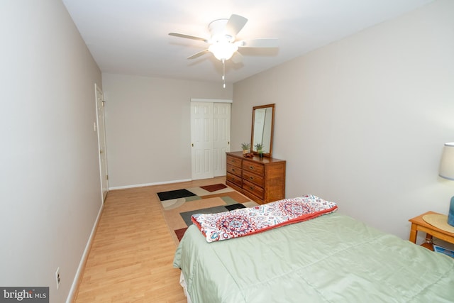 bedroom with baseboards, ceiling fan, a closet, and light wood-style flooring