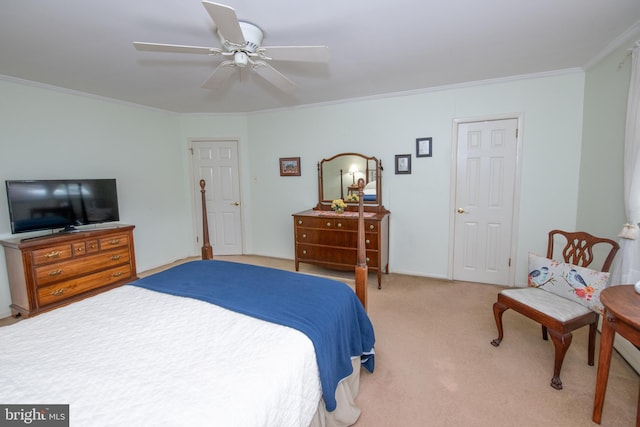 carpeted bedroom featuring ornamental molding and a ceiling fan