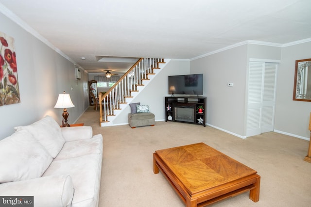 living room with stairway, crown molding, baseboards, and light carpet