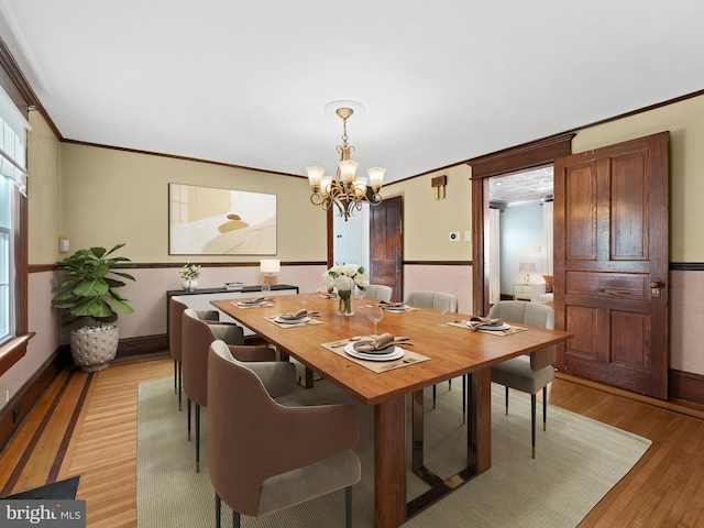 108 Delaware St, Woodbury, NJ 08096 - dining room with a chandelier, light wood finished floors, plenty of natural light, ornamental molding, and baseboards