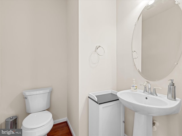 20822 Brunswick Ln, Millsboro, DE 19966 - bathroom with toilet, baseboards, and wood finished floors