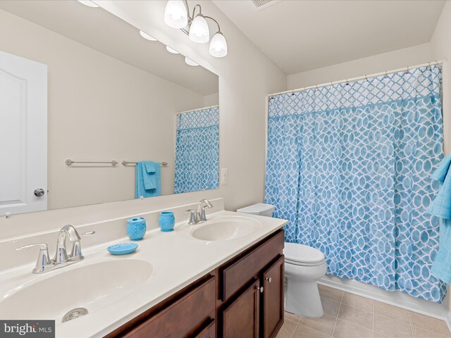 20822 Brunswick Ln, Millsboro, DE 19966 - full bathroom featuring toilet, double vanity, and tile patterned flooring