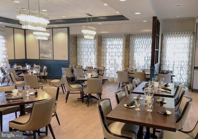 3100 N Leisure World Blvd Unit 507, Silver Spring, MD 20906 - dining space featuring a decorative wall, light wood finished floors, a chandelier, and wainscoting