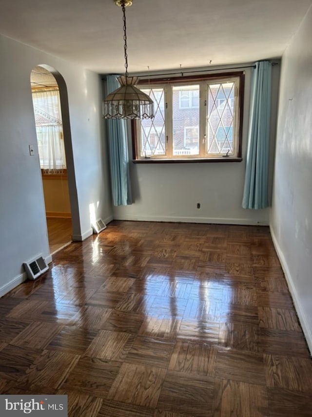 6833 E Roosevelt Blvd, Philadelphia, PA 19149 - unfurnished dining area with a wealth of natural light, visible vents, baseboards, and arched walkways