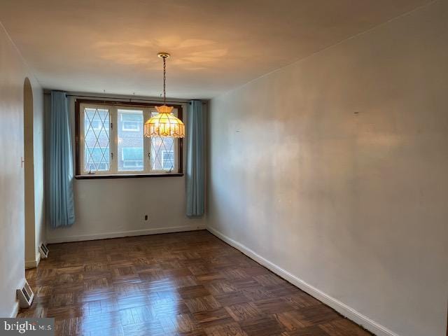 6833 E Roosevelt Blvd, Philadelphia, PA 19149 - unfurnished dining area featuring baseboards and arched walkways