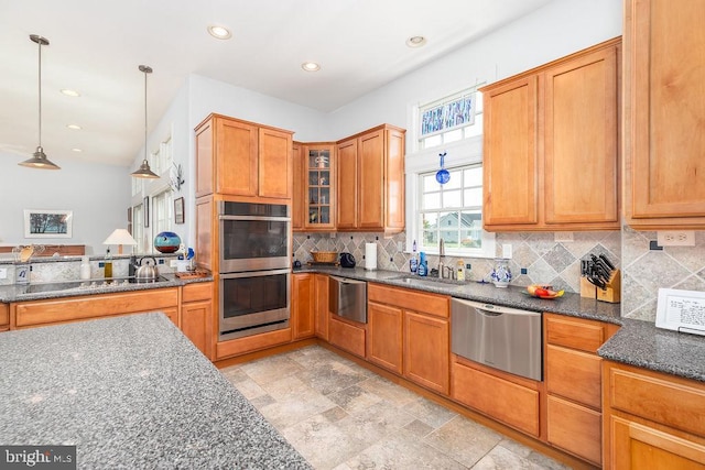 536 Yacht Club Dr, Ocean Pines, MD 21811 - kitchen featuring appliances with stainless steel finishes, a sink, backsplash, dark stone counters, and pendant lighting