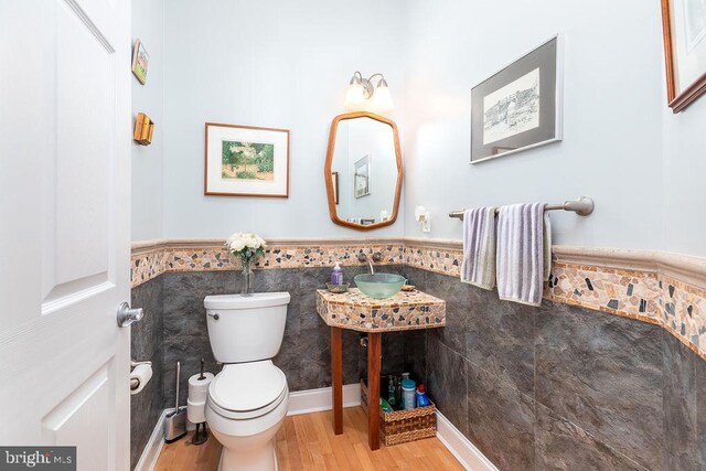 536 Yacht Club Dr, Ocean Pines, MD 21811 - half bath featuring tile walls, wainscoting, toilet, and wood finished floors