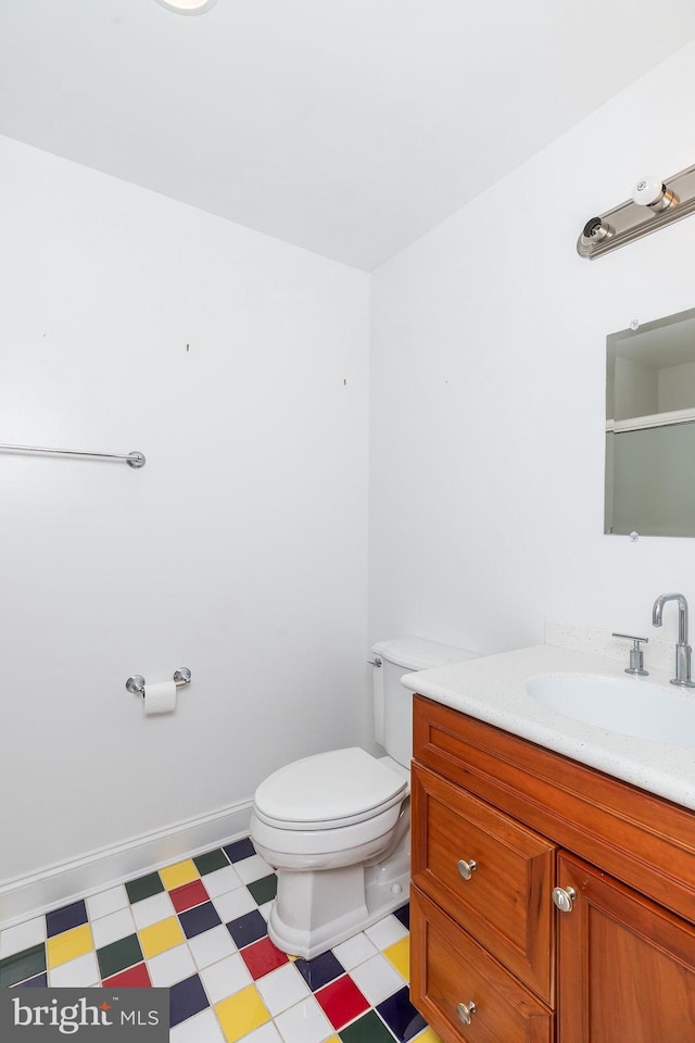 536 Yacht Club Dr, Ocean Pines, MD 21811 - bathroom featuring tile patterned floors, toilet, vanity, and a shower with door