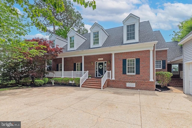 536 Yacht Club Dr, Ocean Pines, MD 21811 - cape cod-style house featuring brick siding, covered porch, roof with shingles, and crawl space