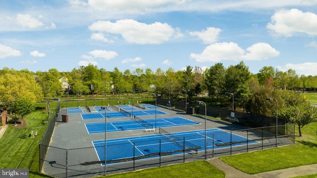 view of sport court featuring fence