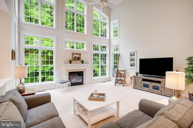 18565 Kerill Rd, Triangle, VA 22172 - living room featuring a towering ceiling, carpet flooring, and a glass covered fireplace