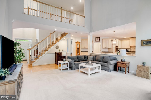 18565 Kerill Rd, Triangle, VA 22172 - living room with a towering ceiling, stairway, baseboards, light colored carpet, and recessed lighting