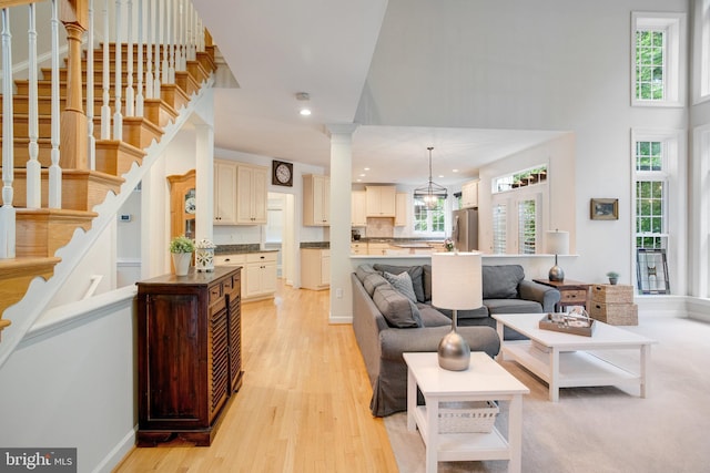 18565 Kerill Rd, Triangle, VA 22172 - living area with healthy amount of natural light, light wood-style flooring, stairway, a high ceiling, and recessed lighting